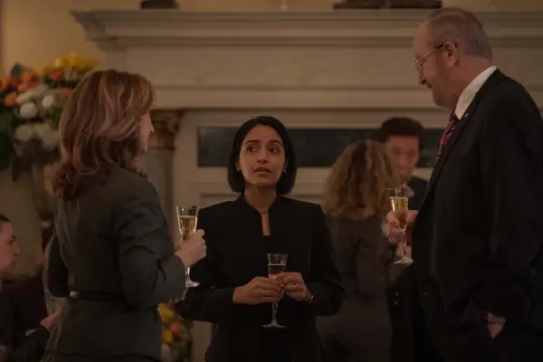 Svetlana Efremova, Coral Peña and Daniel Stern star in For All Mankind gathered together in formal attire, holding drinks glasses