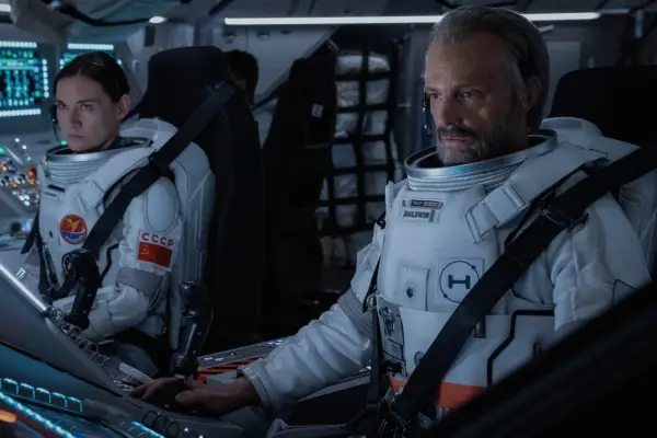 Masha Mashkova and Joel Kinnaman in For All Mankind sat in astronaut