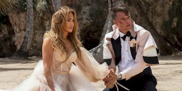 jennifer lopez and josh duhamel sit on the beach in shotgun wedding