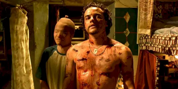 Wagner Moura with wounds on his torso in Carandiru