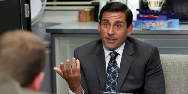Michael Scott from The Office sitting in his office