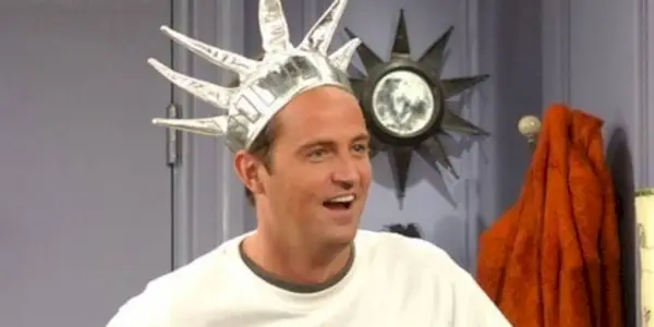 Matthew Perry as Chandler Bing wearing a Statue of Liberty crown in Friends