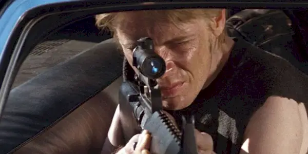 A man aiming a sniper rifle