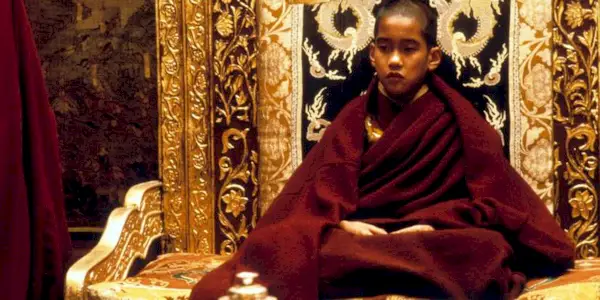 The young Dalai Lama sitting on the throne in 