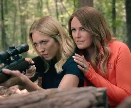 Brittany Snow as Sophie learning how to use a gun with Malin Åkerman as Margo in The Hunting Wives