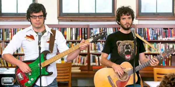 Jemaine Clement and Bret McKenzie playing guitars in Flight of the Conchords