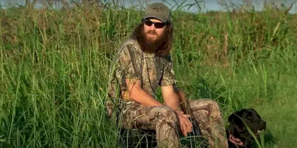 Jase Robertson fron duck dynasty sitting in a field during a duck hunt