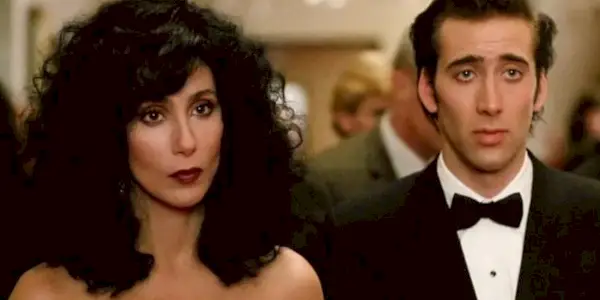 Loretta and Ronny looking intently ahead in Moonstruck