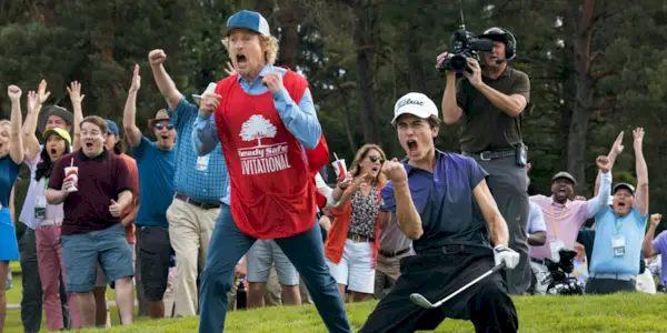 Owen Wilson as Pryce and Peter Dager as Santi getting excited after hitting the golf ball in Stick