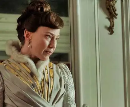 Carrie Coon looking at a portrait in progress