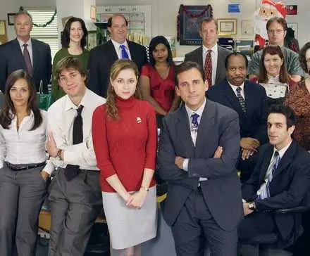 Michael Scott standing with The Office employees