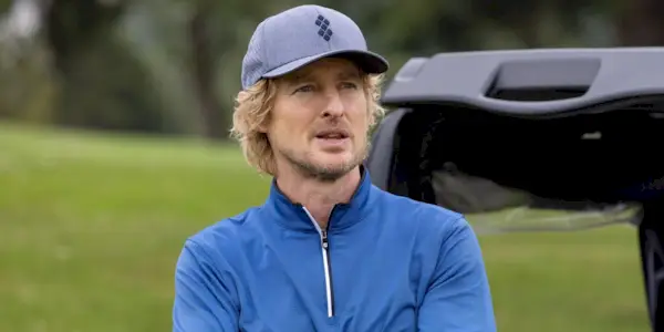 Owen Wilson leaning against a golfcart as Pryce Cahill in Stick.