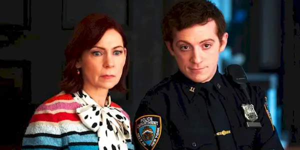 Carrie Preston and Ethan Slater stand side by side and look off screen in 