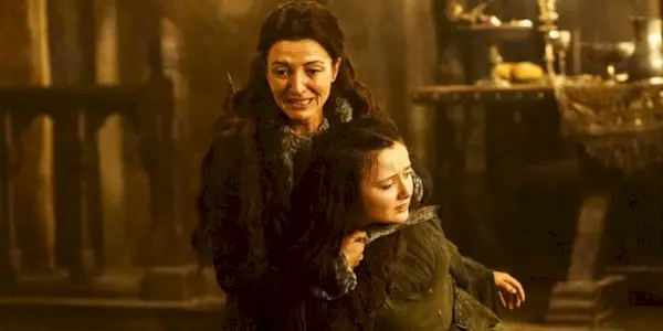 Michelle Fairley as Catelyn Stark crying and holding Frey