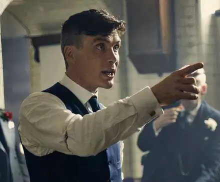 Cillian Murphy as Thomas Shelby, pointing at a man in Peaky Blinders