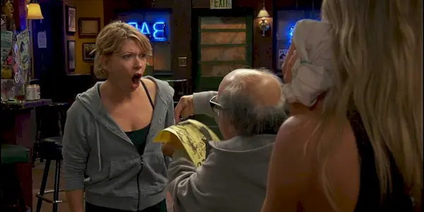 The Waitress looking angry as Frank Reynolds points something out to her on a flyer in It