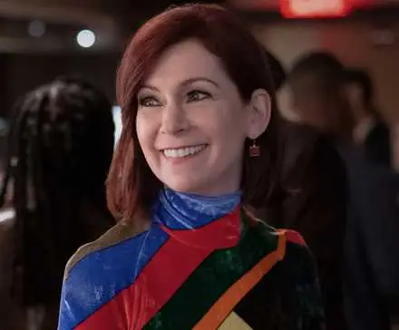 Carrie Preston as Elsbeth Tascioni smiling off camera in a bar setting