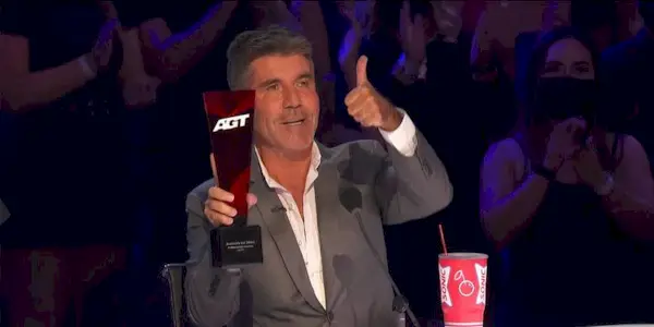 Simon Cowell giving a thumbs up at the judges table on America