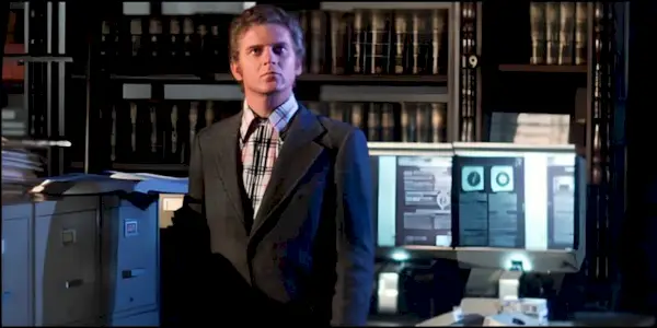 Questor (Robert Foxworth) seen in a room with file cabinets, books and computer monitors in The Questor Tapes.