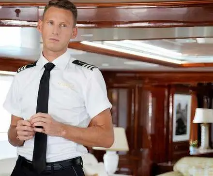 Fraser Olender stands in a cabin as the Chief Stew on 