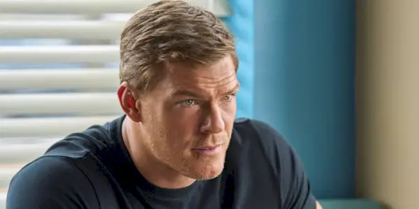 Alan Ritchson as Jack Reacher, looking concerned in Reacher Season 1.