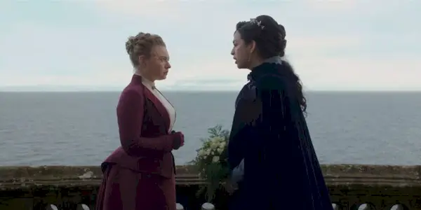 Mia Threapleton and Josie Totah looking at each other in The Buccaneers Episode 8