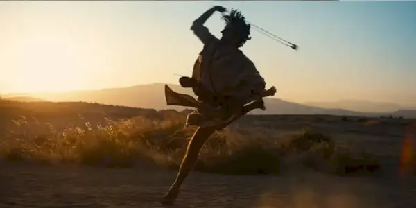 David (Michael Iskander) slings his stone on the battlefield on 