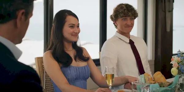 Belly Conklin and Jeremiah Fisher sitting next to each other and smiling at lunch in The Summer I Turned Pretty TSITP Season 3