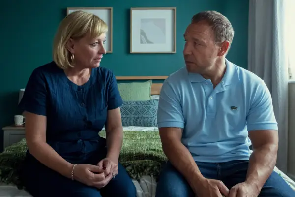 Christine Tremarco and Stephen Graham star in Adolescence sat on a bed