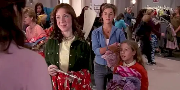 Three girls talking to woman