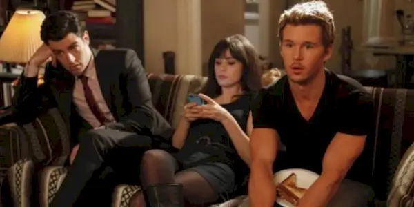 Two men and a woman sitting on couch