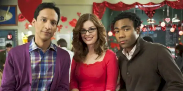 Three people at convention looking into camera