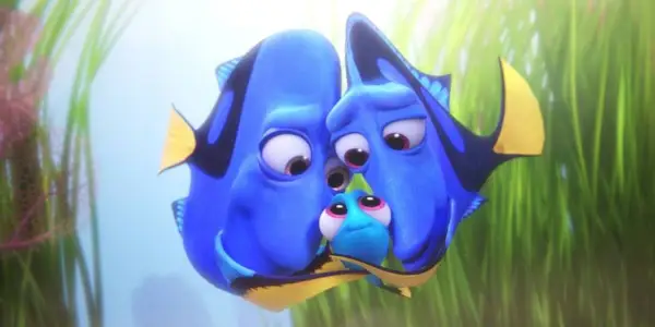 Dory and her parents snuggle together with seagrass behind them in Finding Dory.