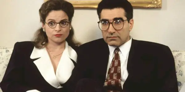 Gwen and Dr. Allan sitting next to each other looking confused in Waiting for Gulfman