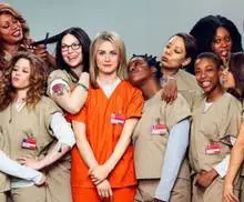 The cast of Orange Is The New Black posing for a group photo.