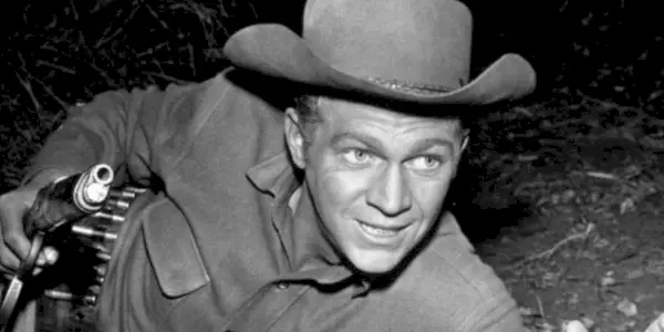 Steve McQueen laying on his stomach with his gun drawn in Wanted Dead or Alive
