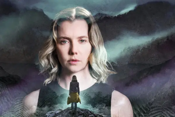 Lauren Lyle as Mia in The Ridge. Her face is superimposed over misty mountains and there is a woman stood below her.